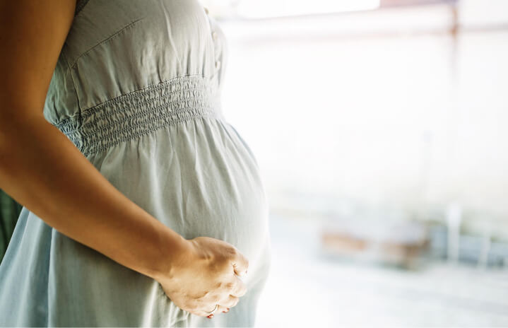 Pregnant Woman holding her stomach