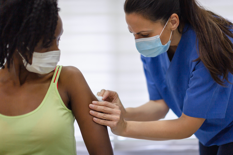 Black woman getting the covid vaccine
